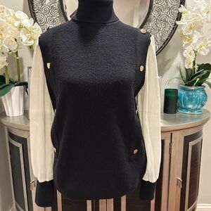 Black and White Sweater with Gold Button Accents and a sheer white sleeve